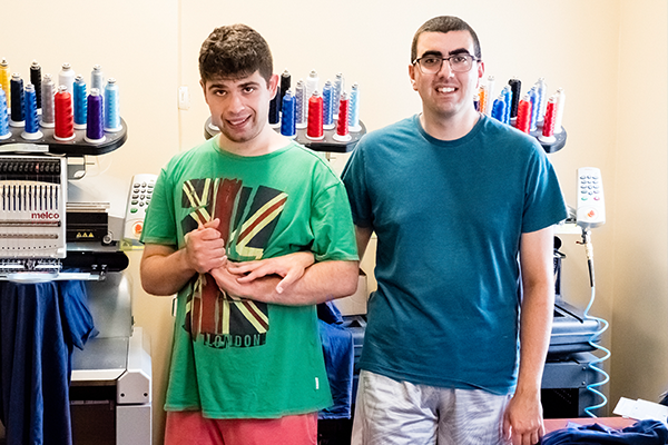 2 employees at a screen printing job