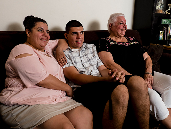 3 generations of family members sitting on the couch