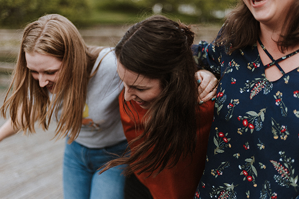 3 girls laughing and hugging