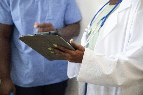 a doctor pointing at a clipboard