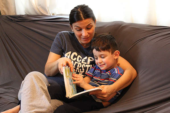 a mother reading her son a book