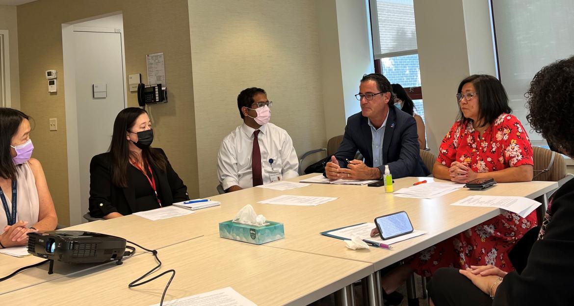 Autism Speaks CEO and Congresswoman Grace Meng sitting at a table