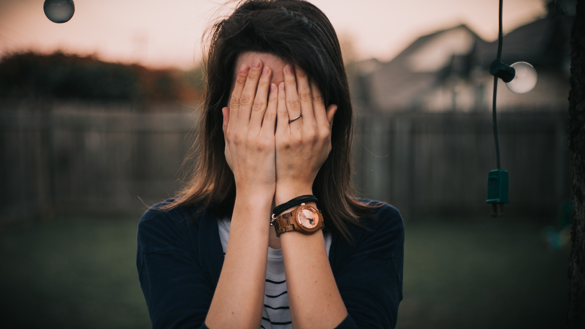 girl covering her face with her hands