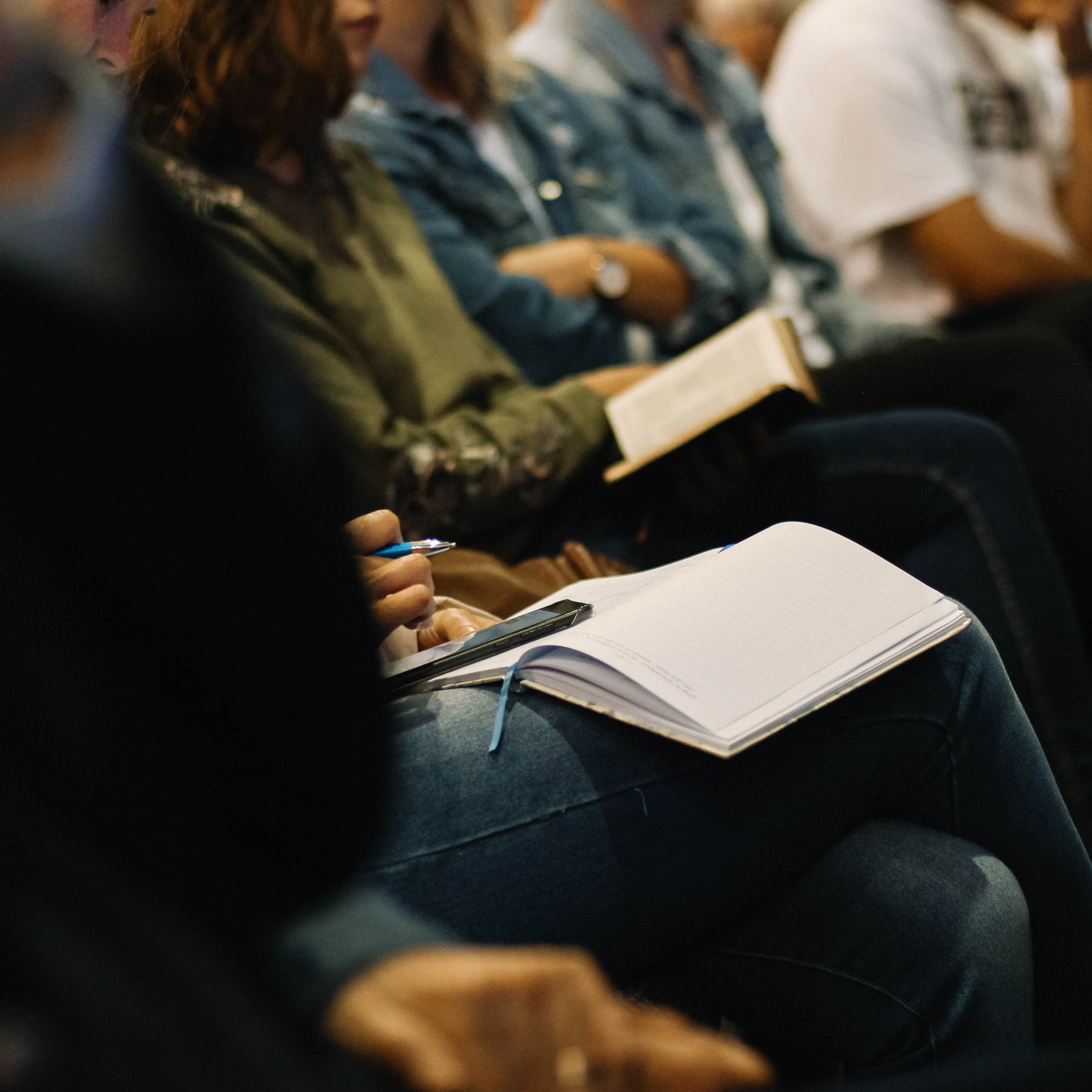 Group of people taking notes