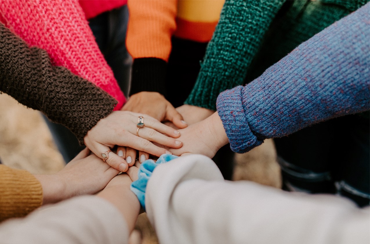 hands stacked on top of each other in a huddle