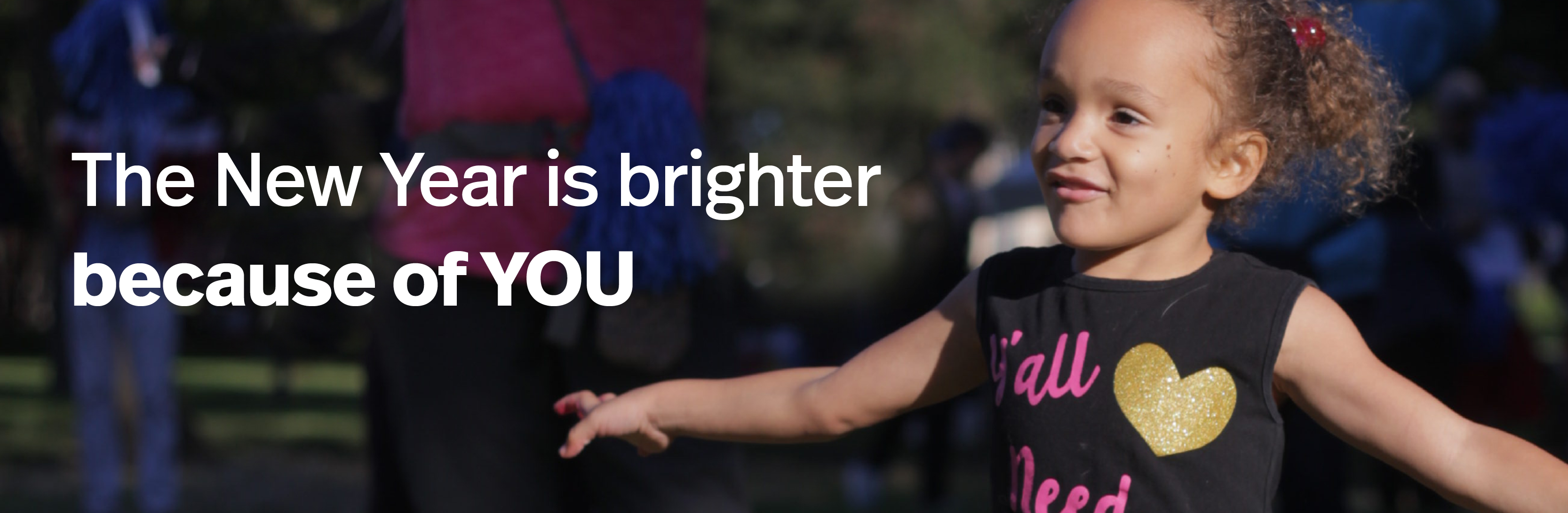 Little girl smiling with her arms out as she dances