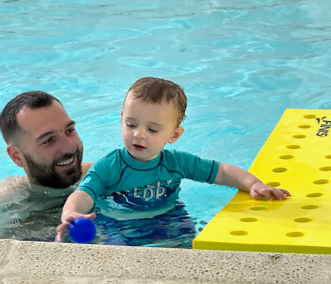 Jack and his dad in a swimming pool