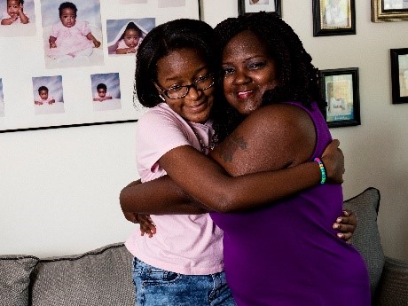 mother and daughter hugging in their living room