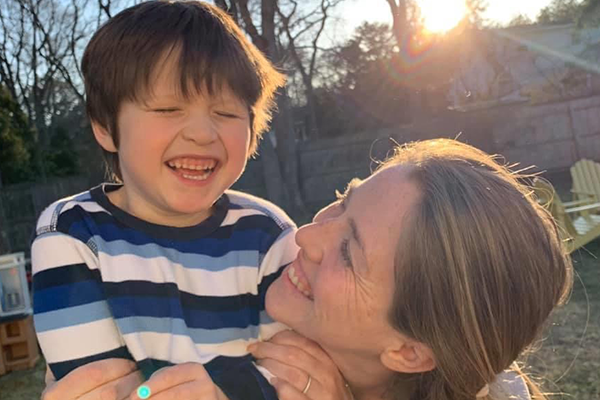 Mother and son smiling in their backyard