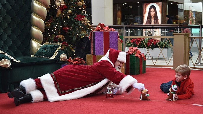 Santa and a child playing with toys together at an autism-friendly Santa event