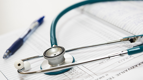 Stethoscope on a pile of documents