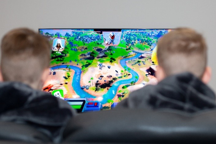 Two young children playing video games together