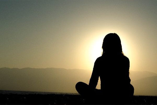 Woman's silhouette watching the sunset