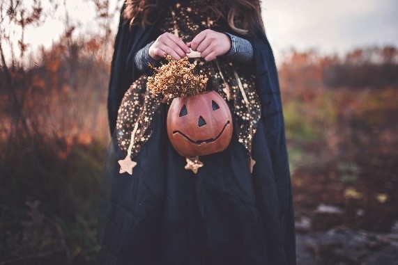 Young girl holding a Halloween bucket