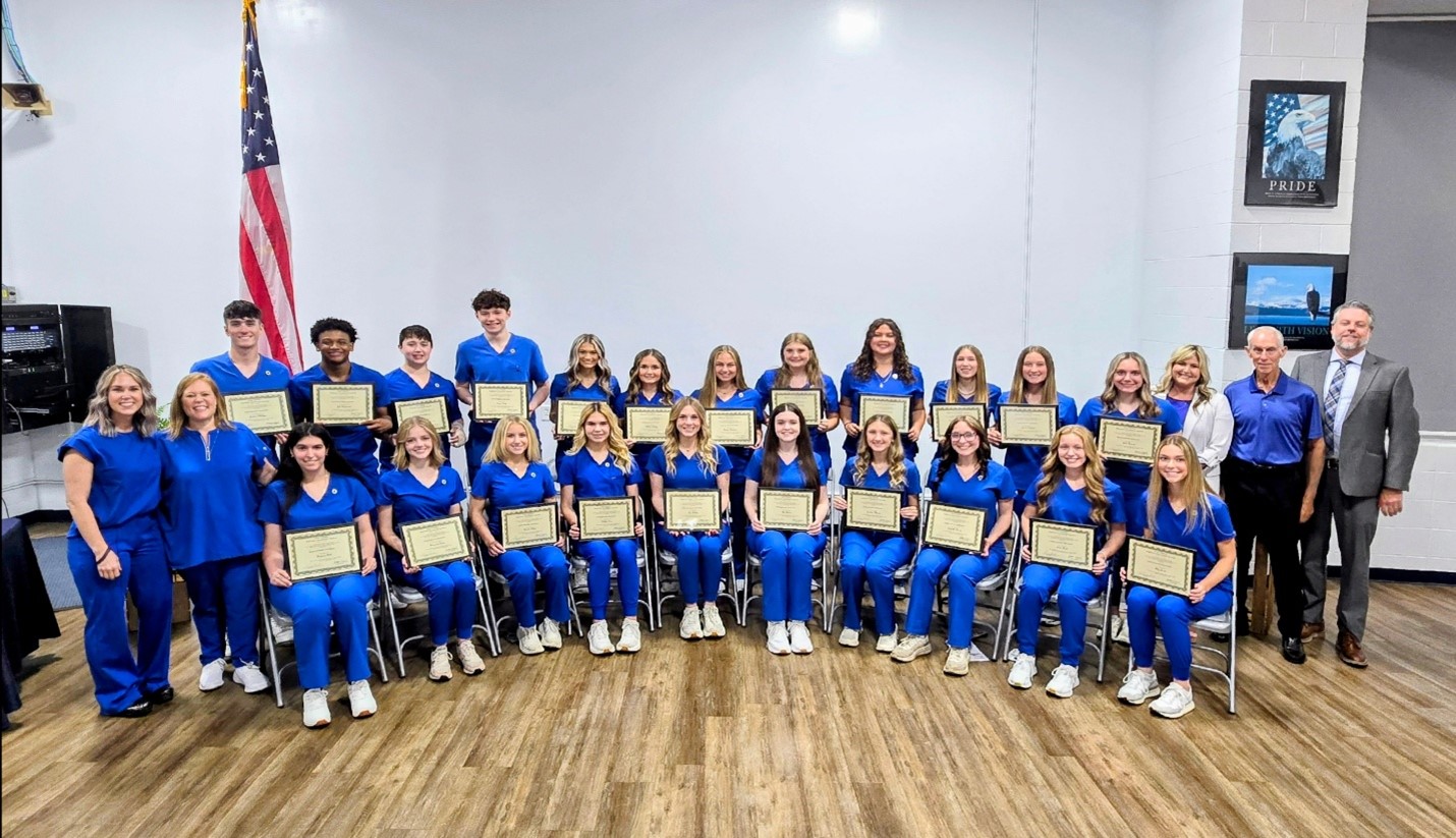 Vienna High School Health Occupations program graduates  pose with their certificates. 