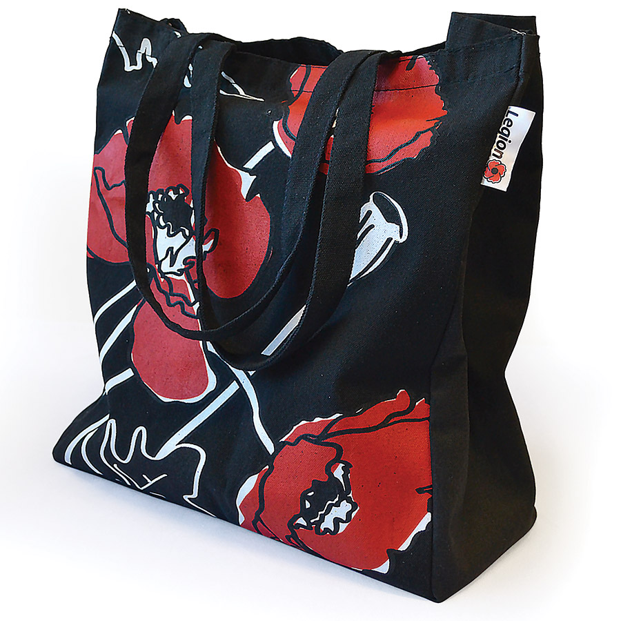 A black canvas shopping bag decorated with poppies in red, black and white.