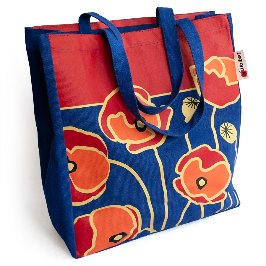 A royal blue canvas shopping bag decorated with stylized red and orange poppies outlined in gold