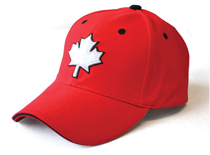 A red ball cap with a white maple leaf on the front.