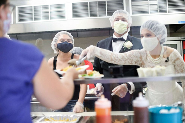 Bride and Groom serving food