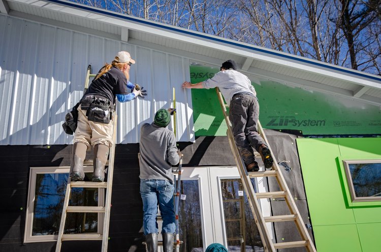 Photo of crew rebuilding a home.