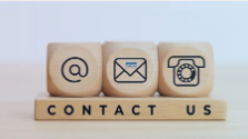 Contact Us and three blocks with an @ symbol, envelope and telephone