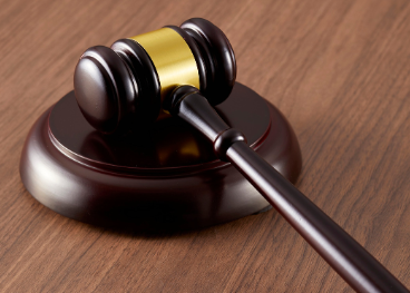 wooden gavel resting on a base